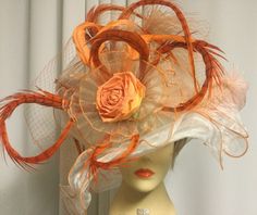 As an award winning hat designer for over 20 years I'd like to share some tips for choosing your hat creation.  First choose your hat, then finish your attire be it a dress, pant suit or casual wear.  A chunky stone necklace that brings the colors from your hat is the perfect accent to complete your stunning event attire..Nancee *Color:  White with peach *Fabrication: Elegant hat base  *Size: Adjustable enter crown tie band for down sizing *Brim size: 15 inch Wide brim *Custom One of a Kind  *All feathers are disease free and custom dyed Hats by Nancee exclusive Ladies One of a kind designer hat Women's Special Occasion Hat Ladies Fascinator Kentucky Derby Ascot hat Oak derby Lilly designer & Wedding creation.  Stunning & Elegant hat base with custom created silk rose accent.  Custom dyed Event Attire, Chunky Stone Necklace, Special Occasion Hats, Elegant Hat, Doll Hats, Dress Pant Suit, Ascot Hats, Hat Base, Elegant Hats