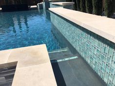 an empty swimming pool with blue tiles on the side