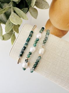 Treat yourself to a touch of luxury with our hand beaded bracelet set. Crafted with care and attention to detail, this bracelet  set boasts a stunning mix of gold filled beads, genuine fresh water pearls, and beautiful green jade and agate stones. Perfect for adding a pop of color and sophistication to any outfit. Details: Bracelet 1: 3mm gold filled beads and green Jade & Agate gemstones Bracelet 2: Mix of Fresh water pearls and green 3mm Jade & Agate gemstones Bracelet 3: Fresh water pearl foc Luxury Jade Beaded Bracelets For Gifts, Jade Gemstone, Fresh Water Pearls, Water Pearls, Layered Bracelets, Green Jade, Focal Bead, Gemstone Bracelets, Look Plus