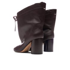 The Brown Tabi Drawstring Ankle Boot in 'Chic Brown' from Maison Margiela. This Italian-made boot features a Nappa upper with a leather sole and a drawstring top closure. It has a leather lining, a slouchy shaft, and a distinctive Tabi split toe. The boot stands on a heel approximately 75mm high with a shaft height of around 165mm. Nappa upper with leather sole Made in Italy Drawstring top closure Leather lining Slouchy shaft Tabi split toe Approx 75mm/ 3 inch heelApprox 165mm/ 6.5 inch shaft St Leather High Ankle Boots With Wrapped Heel, Leather High Ankle Heeled Boots With Wrapped Heel, Leather High Ankle Heeled Boots With Front Lace-up, Leather High Ankle Heeled Boots With Lace-up Fastening, Leather Heeled Boots With Lace-up Fastening, Leather Heeled Lace-up Boots, Leather Heeled Boots With Front Lace-up, Leather Heeled Boots With Front Lace-up Fastening, Leather Ankle Boots With Lace-up Fastening