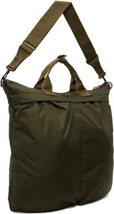 Lightweight nylon canvas tote in khaki. · Press-stud tab at webbing carry handles · Adjustable and detachable crossbody strap · Logo patch at face · Patch pockets and pleats · Zip closure · Zip pocket at interior · Fully lined · H16.5 x W18 x D2 Supplier color: Olive drab Military Style Nylon Bags For Everyday Use, Utility Nylon Bags With Multiple Pockets, Military Travel Bag With Pockets, Khaki Nylon Tote Bag, Military Style Shoulder Bag For Travel, Military Style Travel Bag With Adjustable Strap, Military Style Travel Bag With Multiple Pockets, Military Travel Bags With Adjustable Strap, Khaki Nylon Bag With Removable Pouch