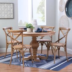 a wooden table with four chairs around it