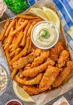 chicken wings with dipping sauce and lemon wedges