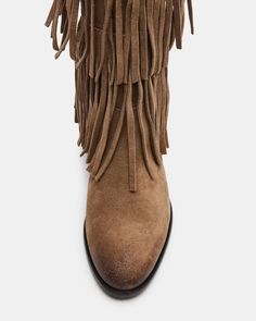 Upgrade your wardrobe with the SPUR fringe boot. These boots feature a fringe detailing that adds a touch of effortless style. Perfect for any occasion, these boots will elevate your look while providing comfort and durability. 1 inch heel height 14.5 inch shaft circumference 15 inch shaft height Suede upper material Synthetic lining Leather sock Synthetic sole Fit tip: If you are in between sizes, size up a half-size Imported Casual Fringe Boots For Fall, Western Suede Fringe Boots, Western Style Suede Boots With Fringe, Casual Suede Fringe Boots, Leather Fringe Boots For Fall, Western Suede Boots With Tassels, Winter Fringe Ankle Boots, Western Fringe Boots For Fall, Winter Suede Boots With Tassels