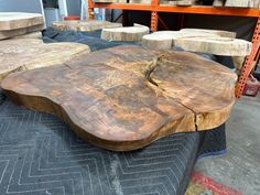 several pieces of wood sitting on top of a table in a room filled with shelves