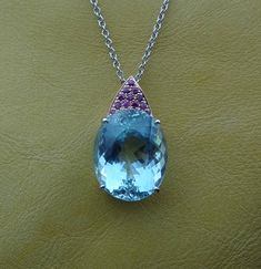 "This handmade one of a kind pendant is made in 14k rose and white gold with a huge fine color natural Aquamarine. The 12 pave set rubies are of fine quality and .36 cts total weight. The 14k white gold chain is included and can be made 16,17 or 18 inch long. We love this pendant because it represents the way jewelry should be made with craftsmanship and quality. This pendant is anything but ordinary. Our pieces are designed and made with craftsmanship and sustainability in mind, our designs are Luxury Oval Cabochon Gemstones, Exquisite Oval Gemstones With Accents, Exquisite Oval Gemstones For Formal Occasions, Exquisite Oval Gemstones For Formal Events, Luxury Oval Gemstones, Luxury Oval Sapphire Gemstones, Oval Luxury Gemstones With Accents, Luxury Oval Gemstones With Accents, Oval Multi-stone Jewelry For Formal Occasions