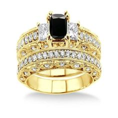 a black and white diamond engagement ring set with matching band, in yellow gold plated