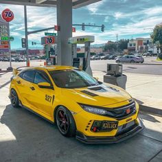 a yellow car parked at a gas station