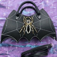 Get ready for Halloween with this stunning Spider Rhinestones Leather Shoulder Bag Handbag! 🕷️🎃 Perfect for a Gothic-style cosplay or just to add some edge to your outfit. This bag features beautiful rhinestone detailing and is made of high-quality faux leather. It's a must-have accessory for any spooky occasion! #HalloweenFashion #GothicStyle #ShoulderBag #SpiderDesign #RhinestoneDetailing #FashionAccessories #ShoulderBag #Halloween #Leather #Black #Rhinestone #Women Gothic Leather Bags For Halloween, Gothic Leather Party Bag, Gothic Satchel Bag For Halloween, Gothic Shoulder Bag For Halloween Party, Rectangular Party Bags For Halloween, Gothic Tote Bags For Halloween, Gothic Halloween Tote Bags, Bags Y2k, Classy Edgy