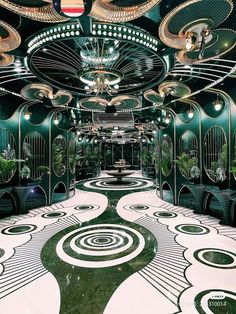 an art deco style hallway with green and white decor on the walls, flooring and chandeliers