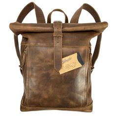 VINTAGE STYLE BACKPACK: This Roll Top Backpack is a timeless, vintage style piece handmade from durable, high quality full grain leather that is sure to last you many years and uses. Featuring two adjustable shoulder straps, you can easily find the right, comfortable fit for you. On the inside, the bag is spacious enough for your laptop and lined with beautiful plaid cotton. The two outside zipper pockets allow for quick access to your cellphone, chapstick, wallet, pen or other small valuables. Roll Top Backpack, Leather Scraps, Top Backpacks, Sunglass Holder, Western Leather, Roll Top, Crossbody Clutch, Slipper Sandals, House Slippers