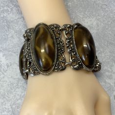 A unique art nouveau style filigree bubble bracelet. Has giraffe looking printed hollow delicate bubbles. A unique delicate type cabochon. Fastens with a hinged clasp closure. Please note adhesive visible on the back side of the bracelet. See pictures. Item in good used condition with very slight indications of vintage wear. See pictures. Size 7 3/8 by 1 5/8 inches Elegant Tortoiseshell Bangle Jewelry, Gold Metal Bracelets With Cabochon, Gold Metal Bracelet With Cabochon, Vintage Resin Jewelry For Parties, Vintage Resin Jewelry For Party, Gold Resin Bracelet, Metal Hinged Bracelets For Gifts, Elegant Adjustable Tortoiseshell Jewelry, Hinged Metal Bracelet As A Gift