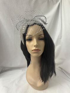 If you are looking for a unique, one of a kind (OOAK)  couture, Fascinator hat to elevate your style, our custom all silver sparking crystal rhinestone fascinator, a stunning blend of 1920s flapper fashion and modern elegance is perfect accessory headpiece for any special occasion. This vintage-inspired Harlem Renaissance or Gatsby style silver mini Fascinator hat features a unique zigzag scalloped edge adorned with dazzling rhinestones, silver metallic dotted veil perfect for weddings, bridal Fascinator headpiece, women's church hat, COGIC conventions, tea parties, cocktail parties, NYE festivities and special occasions. Handcrafted with precision, this luxury half hat is designed for those who seek a one-of-a-kind statement piece that captures the essence of timeless glamour! Easy To wea Flapper Fashion, 1920s Hat, Hat With Veil, Bridal Fascinator, Timeless Glamour, Women Church, Church Hat, Silver Headband, Gatsby Style