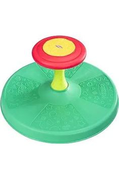 a green frisbee on top of a plastic disc