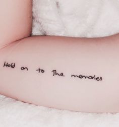 a woman's arm with the words hold on to the memories written in cursive font