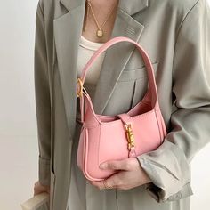 Pink Classic Curved Leather Handbag with Signature Buckle Closure Everyday Use Baguette Bag With Hasp Closure, Daily Use Baguette Bag With Single Handle, Classic Baguette Bag With Hasp Closure, Chic Everyday Baguette Bag With Hasp Closure, Elegant Office Baguette Bag With Metal Hardware, Leather Baguette Bag With Single Handle, Elegant Baguette Tote Bag With Hasp Closure, Elegant Tote Baguette Bag With Hasp Closure, Elegant Single Handle Satchel For Office