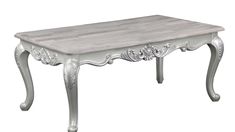 a white wooden table with ornate carvings on the top and bottom edge, against a white background