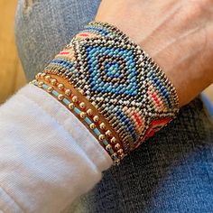 a close up of a person's arm wearing a bracelet with beads on it