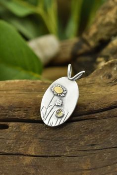 Daisies are said to represent joy, new beginnings, and cheerfulness. These sunny, yellow-gold blooms are sure to bring a smile to the face of anyone who wears one.

Daisies are the birth flower for April and diamond is the birthstone for the month as well, making this the perfect gift for anyone born in April! Handmade by Beth Millner. Yellow Flower-shaped Jewelry For Anniversary, Yellow Flower Shaped Jewelry For Anniversary, Yellow Flower Jewelry For Anniversary, Yellow Flower Jewelry For Mother's Day, Yellow Sterling Silver Flower Jewelry, Yellow Daisy-shaped Jewelry Gift, Yellow Daisy Shaped Jewelry Gift, Yellow Round Jewelry For Mother's Day, Yellow Jewelry For Mother's Day Anniversary