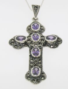 Item Details Marcasite Sterling Silver Oval Amethyst Bezel Set Large Cross w/ Chain GORGEOUS Material: .925 Sterling Silver Weight: 11.50 Grams (Including Chain) Stone: Amethyst (6) Oval Cut Amethyst stones Hand Bezel set along the whole cross. Each stone measures approx. 7x5mm and is approx 1 carat. Dimensions/Size: Cross INCLUDING BAIL measures 2.40 x 1.30 inches Chain: 18in. Box chain. .925 Sterling Silver. Made in Italy. Condition: Brand New Additional Information: This is stunning large cro Amethyst Stones, Cross Jewelry, Fine Jewels, Silver Pieces, Amethyst Stone, Fashion Jewelry Necklaces, 1 Carat, Quality Jewelry, Oval Cut