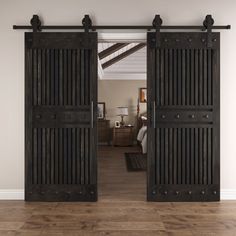 an open door leading to a bedroom with wood floors and white walls in the background