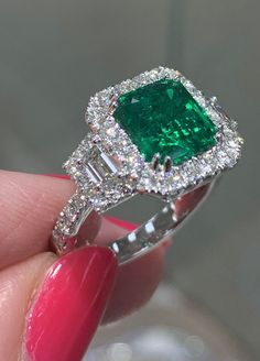 An Emerald statement cocktail ring is a great way to create an elegant, glamorous look.The center stone is emerald-cut in shape and has gorgeous facets. For extra sparkle, it has been framed by 0.39ct tw trapezoid side and 42 round brilliant-cut diamonds 0.70ctw forming a beautiful halo around.Metal: 18K White GoldDiamond Weight : 2 Trapezoid 0.39ct tw, 42 Round-cuts 0.70ct twGRS Certified: GRS2022-018789 / Zambian Emerald Weight: 2.50caratWidth: 12.8mm Emerald Diamond Ring, Zambian Emerald, Shiny Things, Emerald Diamond, Round Brilliant Cut Diamond, Cocktail Ring, Brilliant Cut Diamond, Cocktail Rings, Emerald Cut