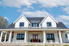 a large white house with black roof and windows