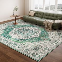 a living room with a green couch and rug