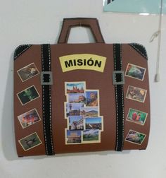 a piece of luggage with pictures on it hanging from the wall next to a door