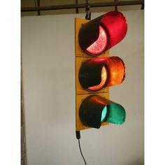 two traffic lights hanging from the side of a wall