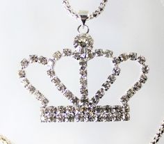 Gold or Silver Jewel Encrusted Crown Pendant, These crown necklaces are perfect for all royalty with all their rhinestones. They would make an exceptional gift for a fashionista. They are exquisite and would make an excellent charm or just as a collectible for the designer at heart. The are about 1.5 in x 2 in and they come with a 28" chain. Party Pendant Rhinestone Necklace With Bling, Dazzling Crystal Rhinestone Necklaces For Gifts, Party Rhinestone Pendant Necklace With Bling, Costume Jewelry With Rhinestones For Gifts, Metal Rhinestone Pendant Necklace, Adjustable Rhinestone Bling Necklace For Gift, Rhinestone Crystal Pendant Necklace With Bling, Crystal Rhinestone Necklace With Diamond Accents Pendant, Crystal Rhinestone Necklace With Jewels As A Gift