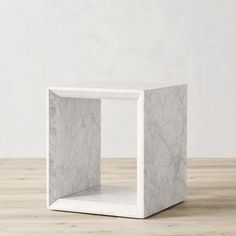 a white marble cube on a wooden table