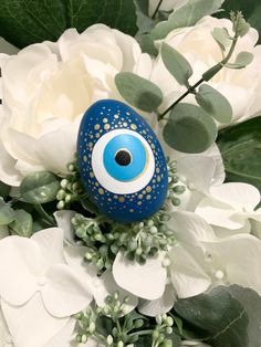 a blue eyeball sitting on top of white flowers