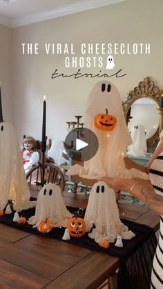 a woman standing in front of a table filled with halloween decorations