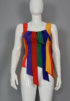 Features: - 100% Authentic MOSCHINO Cheap and Chic. - Carwash panel/ fringe novelty tank in rainbow colors. - Label reads: CHEAP and CHIC by MOSCHINO Made in Italy. - Size tag is missing (mannequin is size 36/38) please refer to the approximate measurements below. - Fabric Content: 79% Acetate, 21% Rayon. - Excellent vintage condition. Measurements taken laid flat, please double bust and waist: Shoulder: 12.99 inches (33 cm) Bust: 15.75 inches (40 cm) Waist: 14.17 inches (36 cm) Length: 29.52 in Rainbow Sleeveless Fitted Top, Multicolor Party Tank Top, Rainbow Fitted Sleeveless Top, Spring Multicolor Color Block Tank Top, Fitted Rainbow Sleeveless Top, Multicolor Fitted Tops For Pride, Fitted Multicolor Tops For Pride, Rainbow Fringe, Vintage Moschino