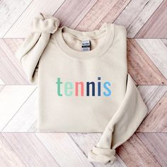 Tennis Sweatshirt for Women Tennis Sweater Preppy Sweatshirt Tennis Gifts for Women Tennis Apparel Tennis Mom Gift Preppy Tennis Sweater PRODUCT DETAILS 50% cotton, 50% polyester Unisex, crewneck sweatshirt Pre-shrunk, air-jet spun yarn Image & text are printed with ink (DTG printing) Gildan brand SIZING Unisex sizing Please refer to the size chart in listing images to ensure correct fit Size up for a slouchier fit CARE INSTRUCTIONS Machine wash cold, inside-out, gentle cycle Use mild detergent Sporty Multicolor Cotton Sweatshirt, Sporty Multicolor Cotton Sweater, Multicolor Cotton Sports Sweatshirt, Sporty Multicolor Crew Neck Sweatshirt, Sporty Multicolor Letter Print Sweatshirt, Multicolor Crew Neck Sweatshirt For Sports, Sporty Multicolor Top With Ribbed Cuffs, Tennis Sweatshirt, Yarn Images