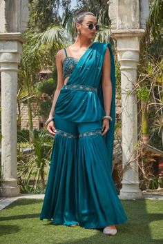 Teal green pre-draped concept saree with sequin embroidery and attached drape. Comes with an embroidered blouse embellished by beads and sequins and belt. - Aza Fashions Draped Sharara With Sheer Dupatta, Silk Draped Sharara For Wedding, Draped Silk Sharara For Wedding, Wedding Silk Draped Sharara, Festive Draped Sharara With Mirror Work, Party Wear Draped Sharara With Cutdana, Party Sharara With Cutdana And Draped Design, Bollywood Style Draped Sharara With Mirror Work, Fitted Embellished Draped Sharara