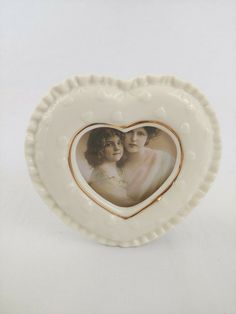 a heart shaped plate with two women in it