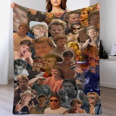 a woman is holding up a blanket with many pictures on it