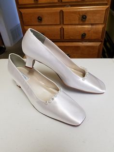 "Beautiful elegant pump style shoes, for the minimalist bride who loves chic shoes! HEEL square, as shown in white: 1 1/2\" If, you prefer the champagne pictured heels (up to size 12, 12W) please click on link below: www.etsy.com/listing/703287418/gold-pump-shoesgolden-anniversary? Please look at the pictures for details such as the gold tone bling brooches adding a very special Elegant & Chic touch. COLOR AVAILABLE: Champagne, Silver, White, Off-White, Ivory SIZES AVAILABLE: M (Medium width Classic Wedding Heels With Padded Heel, Classic Wedding Shoes With 4-inch Heel, Classic 4-inch Heel Wedding Shoes, Classic Cream Closed Toe Wedding Shoes, Classic Cream Almond Toe Wedding Shoes, Classic Pointed Toe Kitten Heels For Wedding, Classic Kitten Heels With Pointed Toe For Wedding, Classic White Closed Toe Wedding Shoes, Classic White Wedding Shoes With 4-inch Heel