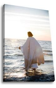 a person standing in the water with a white robe over their shoulders and arms stretched out