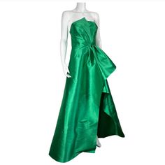 Elliatt Protea Gown In Emerald Green Xs Brand New Polyester Blend Dry Clean Recommended Partially Lined Hidden Back Zipper Closure With Faux Button Overlay Cinched Waist With Exaggerated Fabric Overlay Satin Fabric With Subtle Sheen Finish Neckline To Hem Measures Approx 63" In Length (26) Luxury Green Pre-draped Evening Dress, Elegant Green A-line Gown, Pre-draped Green Evening Dress, Green Gala Gown With Pleated Bodice, Green Fitted Gown With Pleated Bodice, Green A-line Evening Dress For Gala, Green Evening Dress With Pleated Bodice, Fitted Green Gown With Pleated Bodice, Fitted Green A-line Gown