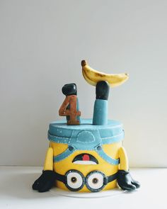 a yellow and blue toy sitting on top of a table next to a banana peel