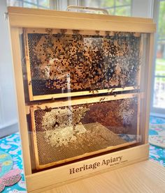 a wooden frame filled with lots of bees