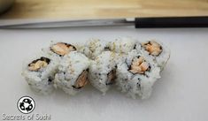 sushi rolls with shrimp on top are ready to be eaten