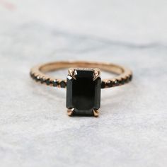 a black diamond ring on top of a table