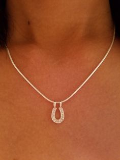 "This Beautiful Equestrian Jewelry genuine .925 Sterling Silver CZ Horse Shoe Pendant on 16\" is the perfect addition for the horse lovers jewelry . We also have a Chain on 18\"and 20\" This horse shoe pendant 1/2\" by 5/ 16, the total weight of this necklace is 0.8 grams. We have recreated this fashioned in to our earrings and pendants. This is a link of earrings: https://etsy.me/2mgJX6k I guarantee all my sterling silver pieces to be genuine .925 and are stamped as such We believe in using bet Elegant Horseshoe Jewelry With Horse Design, Elegant Horseshoe-shaped Horse Design Jewelry, Western Style Silver Jewelry For Shows, Western Style Silver Horseshoe Jewelry, Horseshoe Shaped Sterling Silver Necklaces, Silver Sterling Silver Horseshoe Necklace, Classic Sterling Silver Horseshoe Jewelry, Classic Horseshoe-shaped Sterling Silver Jewelry, Horse Jewelry Necklaces