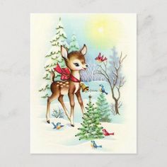 a deer standing next to a christmas tree with birds flying around it in the snow