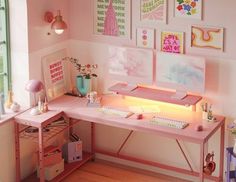 a pink desk with pictures on the wall