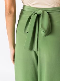 Pear-green silk silk palazzo pants from AMIR SLAMA featuring palazzo design, high waist, rear tie fastening and floor-length. | AMIR SLAMA Silk Palazzo Pants Olive Wide Leg Pants For Spring, Elegant Wide Leg Pants With Tie Waist For Spring, Elegant Spring Wide Leg Pants With Tie Waist, Chic Olive Summer Pants, Elegant Green Wide Leg Pants With Elastic Waistband, Silk Wide Leg Summer Trousers, Chic Green Tie-waist Bottoms, Elegant Green Wide Leg Pants, Chic Green Bottoms With Tie Waist